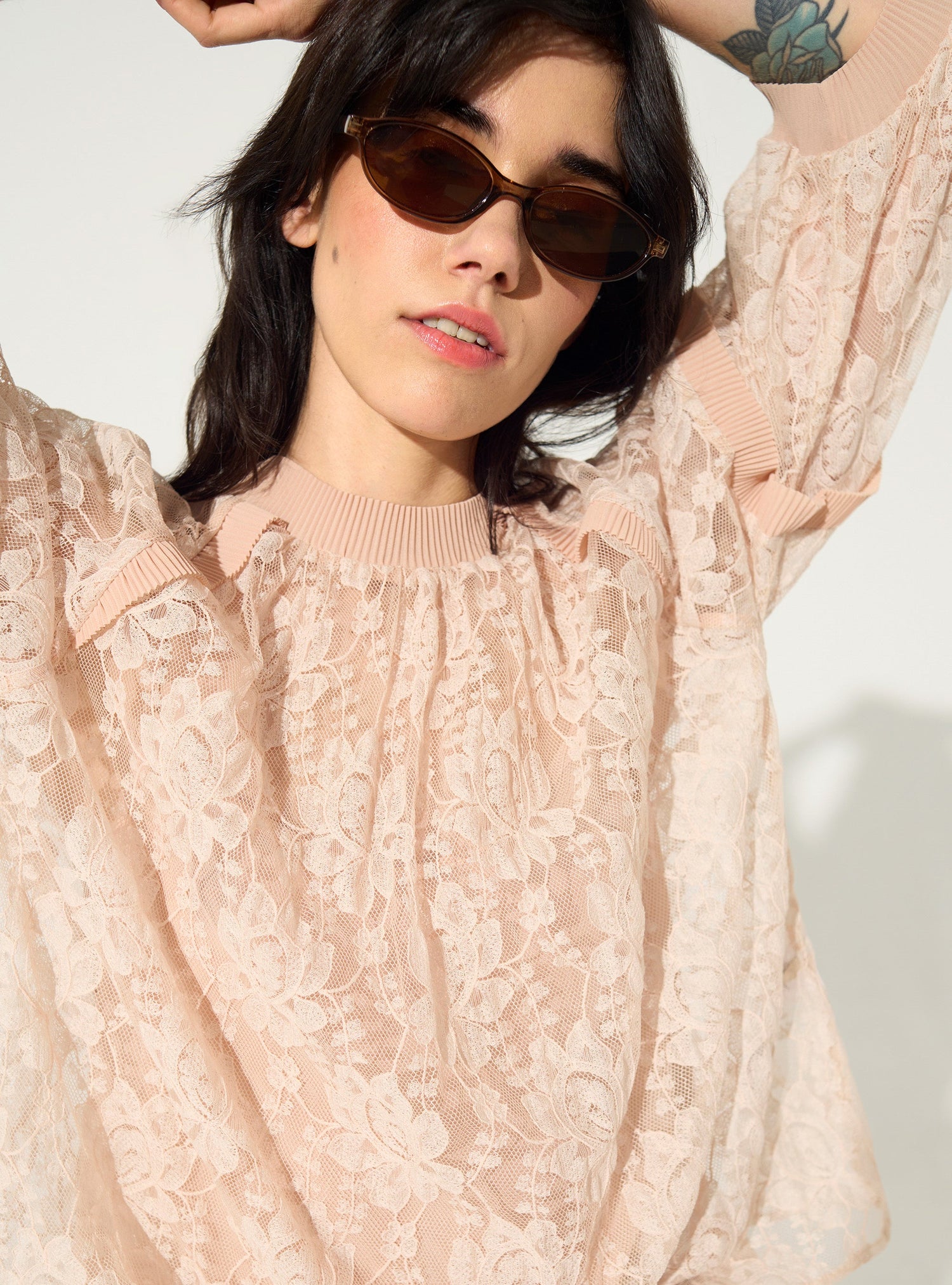 loose-fitting pleated pink lace blouse